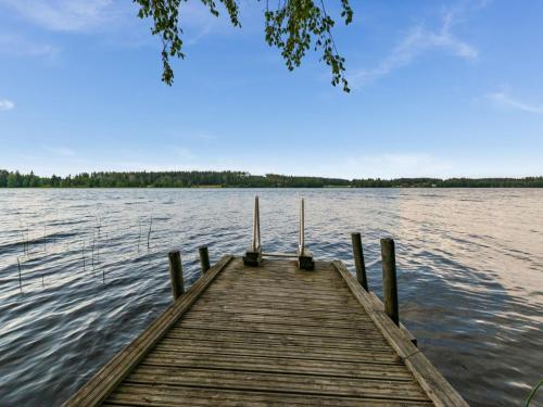 a wooden dock on a body of water at Holiday Home Iltarusko by Interhome in Hara