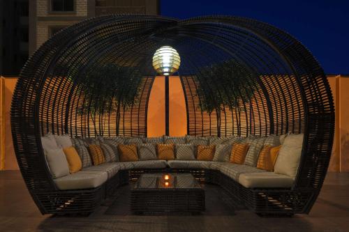 a large wicker couch in a room with a lamp at Radisson Blu Hotel, Addis Ababa in Addis Ababa