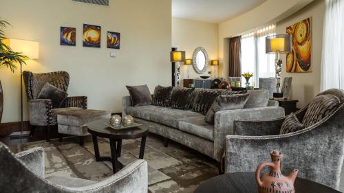 a living room with a couch and chairs at Radisson Blu Hotel, Addis Ababa in Addis Ababa