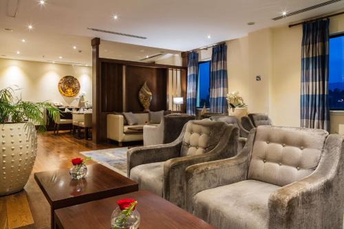 a living room with couches chairs and a table at Radisson Blu Hotel, Addis Ababa in Addis Ababa