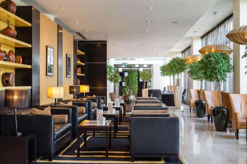 a restaurant with couches and tables in a lobby at Radisson Blu Hotel, Addis Ababa in Addis Ababa