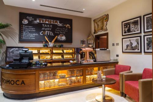 a restaurant with a counter with a display of food at Radisson Blu Hotel, Addis Ababa in Addis Ababa