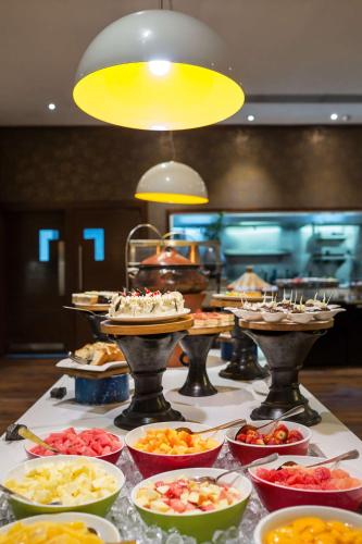 a buffet with many plates of food on a table at Radisson Blu Hotel, Addis Ababa in Addis Ababa