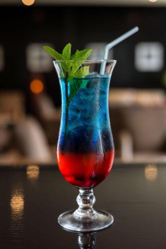 a drink in a glass sitting on a table at Radisson Blu Hotel, Addis Ababa in Addis Ababa