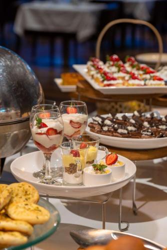 a table with plates of food and glasses of wine at Radisson Blu Hotel, Addis Ababa in Addis Ababa