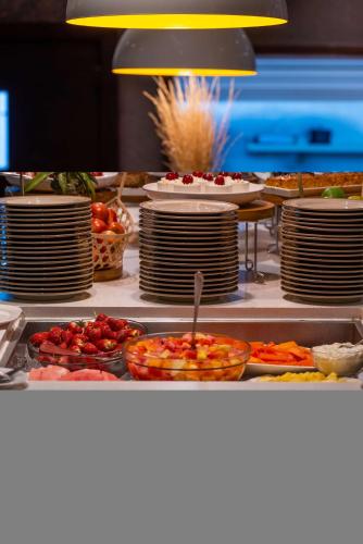 a buffet with plates of food on a table at Radisson Blu Hotel, Addis Ababa in Addis Ababa