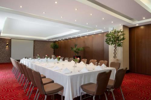 a conference room with a long table and chairs at Radisson Blu Hotel, Addis Ababa in Addis Ababa