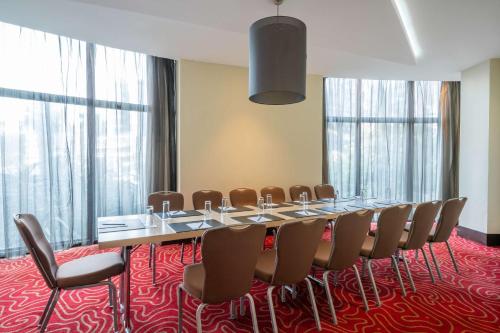 a conference room with a long table and chairs at Radisson Blu Hotel, Addis Ababa in Addis Ababa