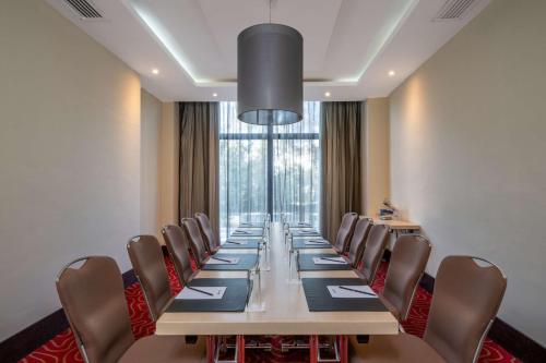 a conference room with a long table and chairs at Radisson Blu Hotel, Addis Ababa in Addis Ababa
