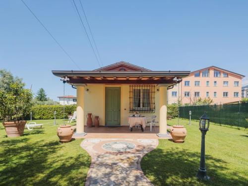 a small house with a table in the yard at Holiday Home Colli by Interhome in Massa