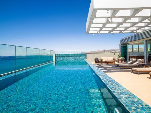 a swimming pool on the roof of a building at The Tower at St Raphael Resort in Limassol