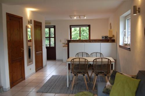 a kitchen and dining room with a table and chairs at Appartement Fleurs des champs - Esc'Appart in Rochefort