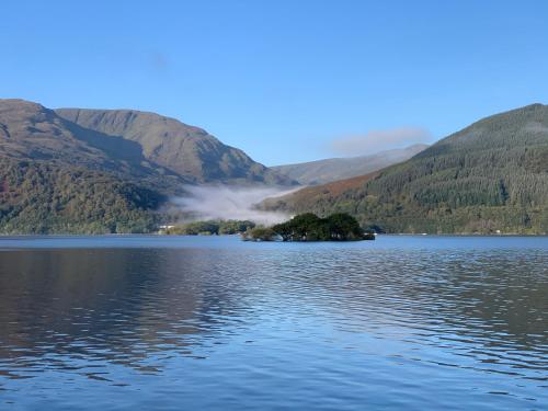 a small island in the middle of a lake at Ben Lomond Lodge in Rowardennan