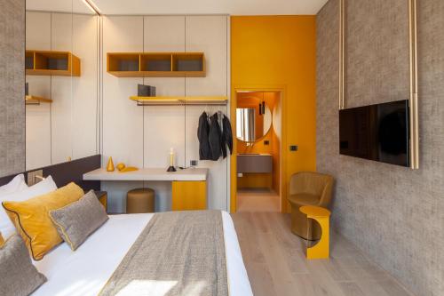 a bedroom with a bed and a desk and a tv at Palazzo Pianca in Venice