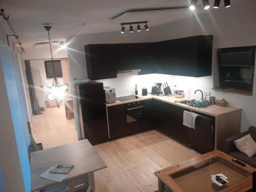 a kitchen and living room with a table and a counter top at Tiny House FAMILY Ruheoase in Zwettl Stadt