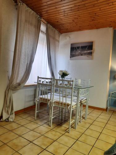 a table and chairs in a room with a window at Romantic Studio Center in Colmar