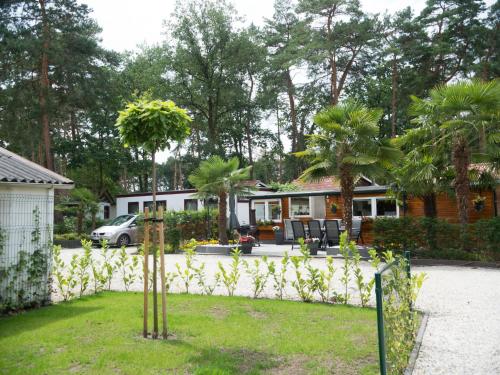 a house with a fence in front of a yard at Holiday Home De Brenkberg-1 by Interhome in Schinveld