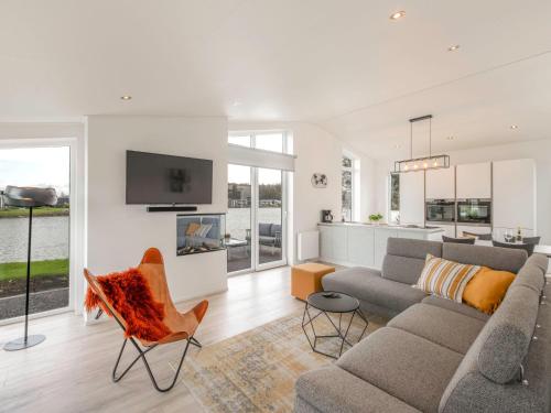 a living room with a couch and a tv at Holiday Home Ruisweg 28 by Interhome in Wemeldinge