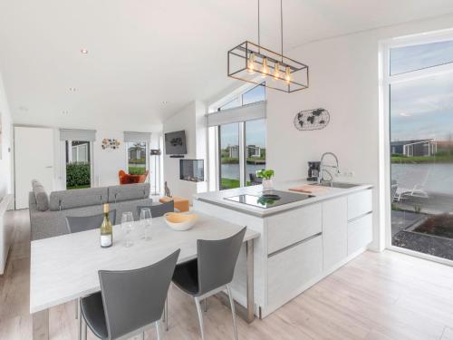 a kitchen and living room with a table and chairs at Holiday Home Ruisweg 28 by Interhome in Wemeldinge
