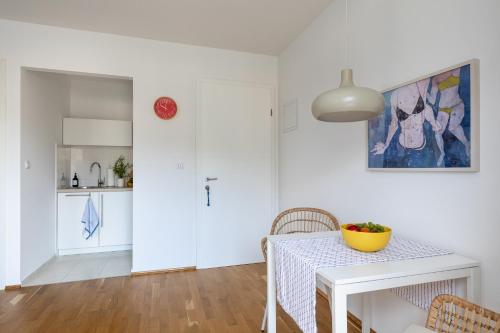 a kitchen and dining room with a table and chairs at Apartments Silvija in Mokošica