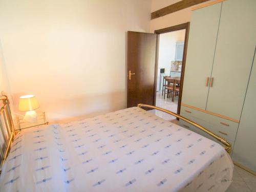 a bedroom with a bed and a door to a dining room at Holiday Home Daniela by Interhome in Luino