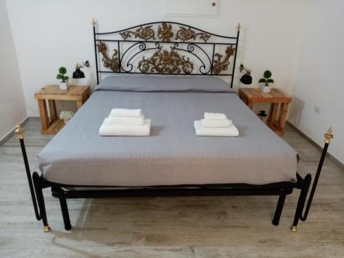 a bedroom with a bed with two towels on it at I Nidi di Colombo in Castrignano del Capo