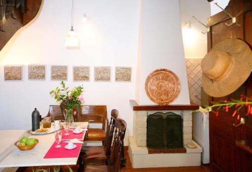 comedor con mesa y chimenea en Myron House, en La Canea