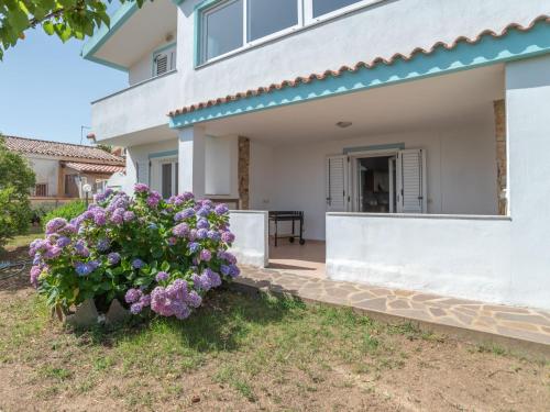 a house with purple flowers in front of it at Apartment Mari by Interhome in Olbia