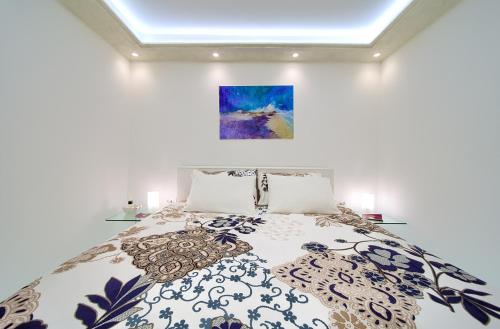 a bedroom with a bed and a painting on the wall at Casa Aurelia - Mali Tone in Krk