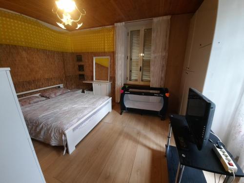 a bedroom with a bed and a desk and a television at Cilento e mare in Rodio