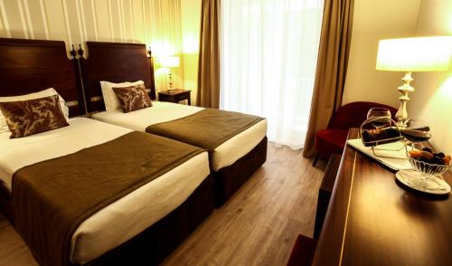 Cama o camas de una habitación en Grão Vasco - Historic Hotel and SPA