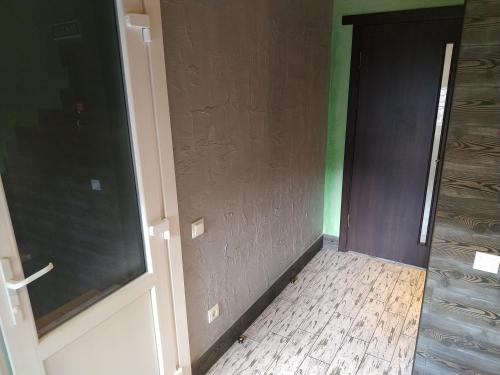 an empty room with a door and a wooden floor at Svitiaz Griada in Szack