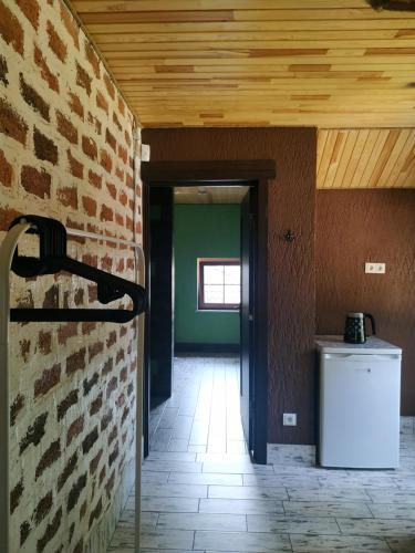 an empty room with a brick wall and a trash can at Svitiaz Griada in Szack
