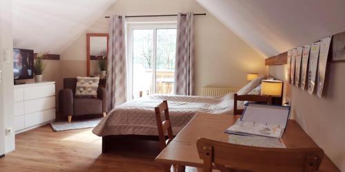 a bedroom with a bed and a table with a laptop at Book-A-Room Salzburg Apartment 5-6-7-8 in Salzburg