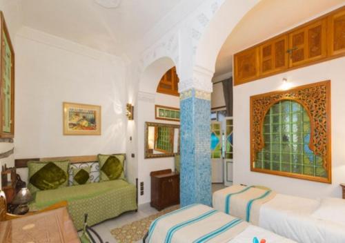 En eller flere senge i et værelse på Riad Maison Arabo-Andalouse