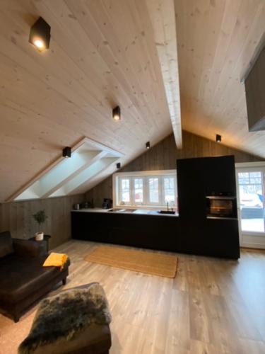 a large living room with a couch and a table at Villa Solsiden Geilo in Geilo