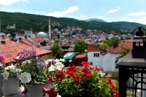 a view of a city with flowers in buckets at HANI I VJETER Boutique Hotel in Prizren