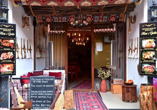 a restaurant with a sign in front of a building at HANI I VJETER Boutique Hotel in Prizren