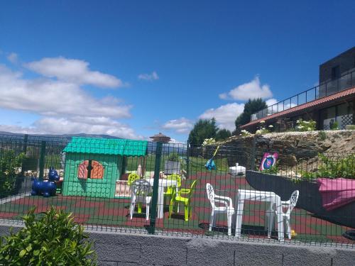 a playground with a table and chairs in a fence at Quinta da Corujeira in Vila Real