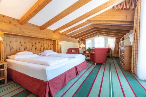 Postel nebo postele na pokoji v ubytování Hotel Kaiserhof Kitzbühel, 4 Sterne Superior