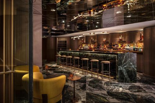 a bar with a row of bar stools at The Londoner in London