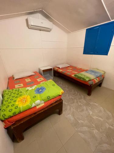 a room with two beds in a room at Dolphin Camp in Dahab