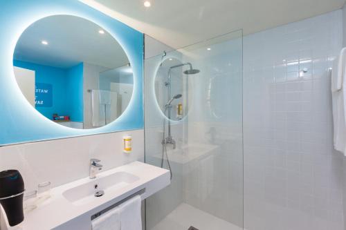 a bathroom with a white sink and a mirror at Abora Interclub Atlantic by Lopesan Hotels in San Agustin