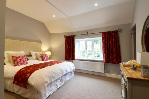 a bedroom with a large bed and a window at The New Inn Halse in Taunton