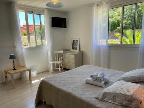 a bedroom with a bed with two towels on it at "Cap Riviera" Hotel & Restaurant Saint Aygulf in Saint-Aygulf