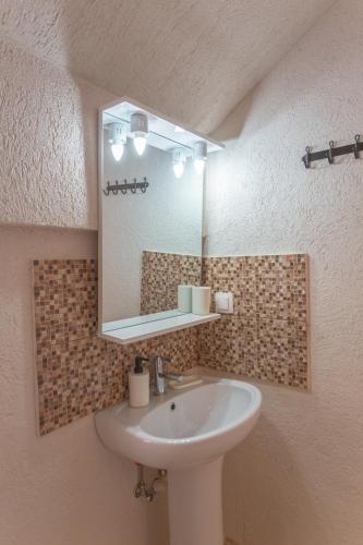 a bathroom with a sink and a mirror at Black Sea View Costinesti in Costinesti