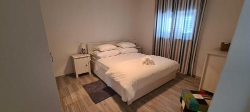 a small bedroom with a bed and a window at Holiday Home Ivo in Sevid