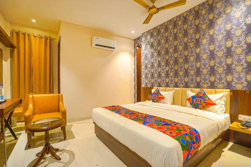 a bedroom with a bed and a desk and a chair at FabHotel Prime Empire in Amritsar