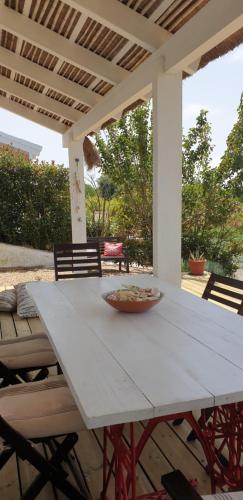 a white table with a bowl on it on a patio at Comporta House in Comporta