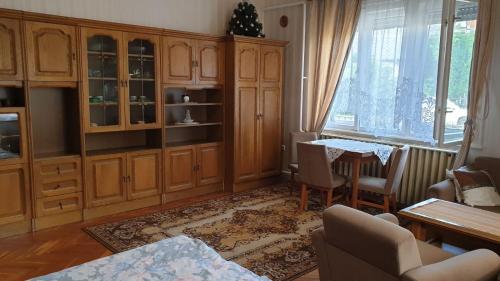 a living room with a table and a dining room at Pipacs apartmanok in Balatonboglár